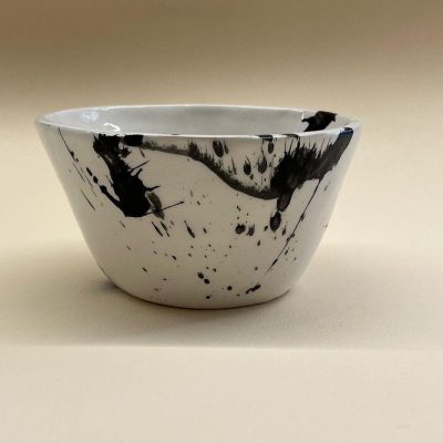 white plant shaped bowl with black brushes