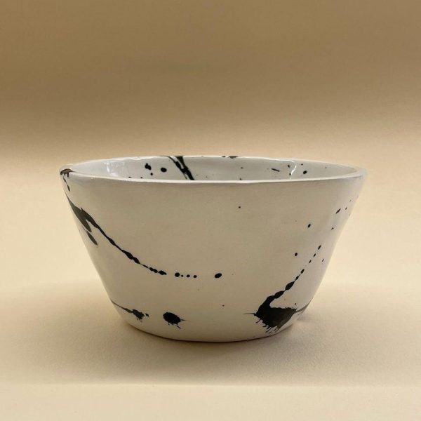 white plant shaped bowl with black brushes
