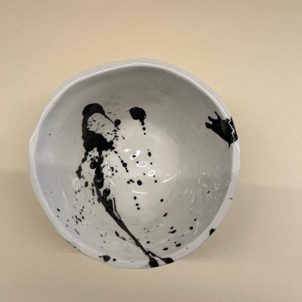 white plant shaped bowl with black brushes