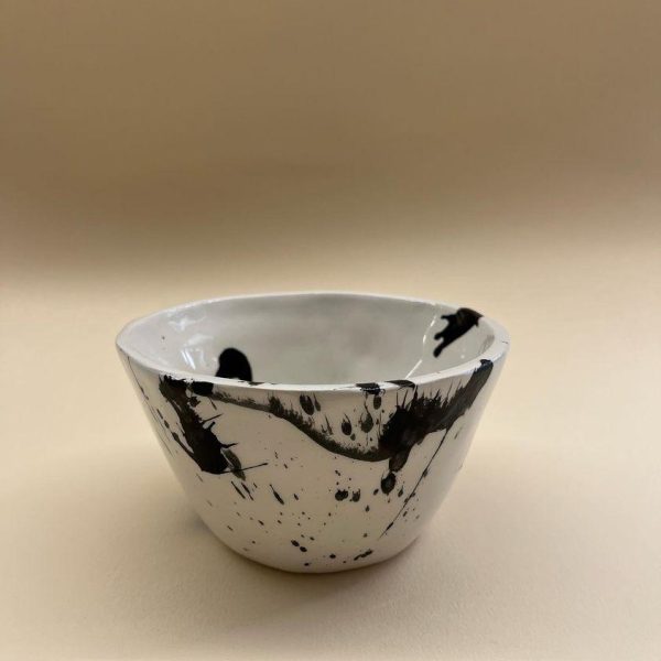 white plant shaped bowl with black brushes