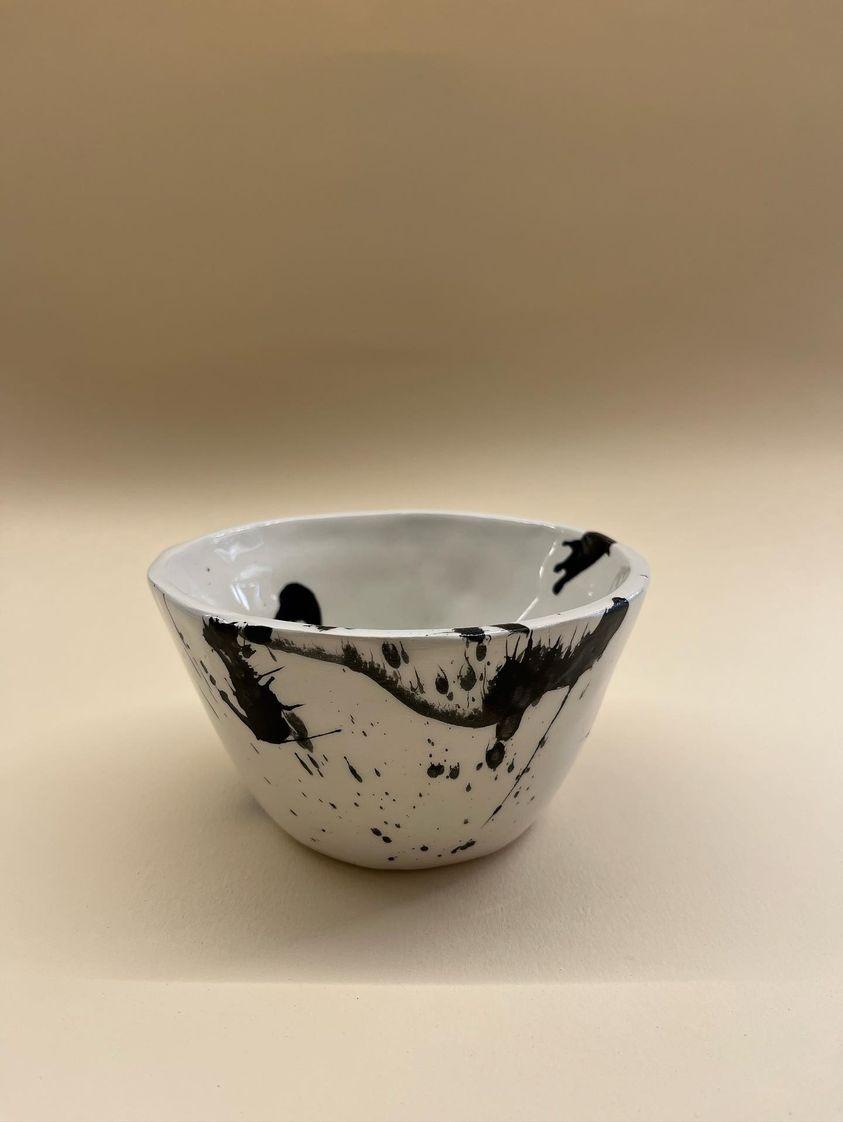 white plant shaped bowl with black brushes