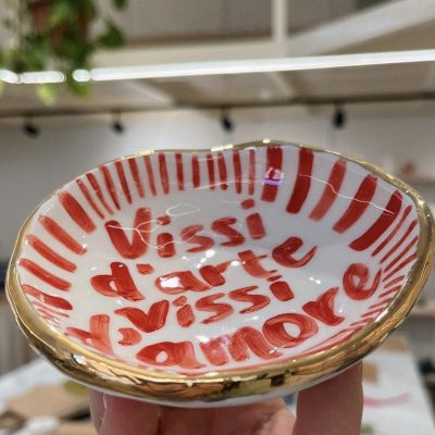 white plate with red stripes and text in red letters